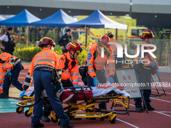 Paramedics participate in a counter-terrorism exercise at Kai Tak Sports Park in Hong Kong on December 17, 2024. (