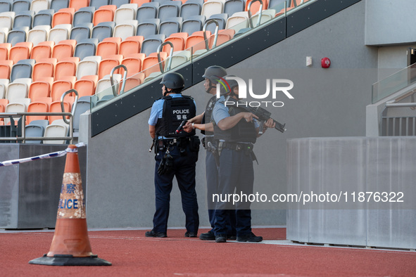 Police officers stand guard at Kai Tak Sports Park during a counter-terrorism exercise in Hong Kong, on December 17, 2024. 