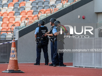 Police officers stand guard at Kai Tak Sports Park during a counter-terrorism exercise in Hong Kong, on December 17, 2024. (