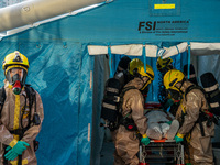 Firefighters decontaminate a person at Kai Tak Sports Park during a counter-terrorism exercise in Hong Kong on December 17, 2024. (