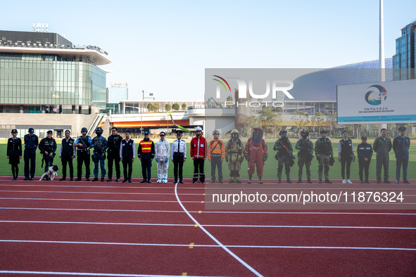 Members of different government departments pose for a group photo at Kai Tak Sports Park during a counter-terrorism exercise in Hong Kong,...