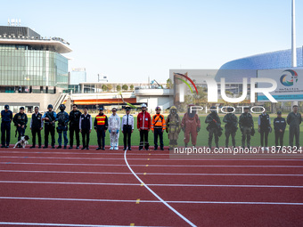 Members of different government departments pose for a group photo at Kai Tak Sports Park during a counter-terrorism exercise in Hong Kong,...