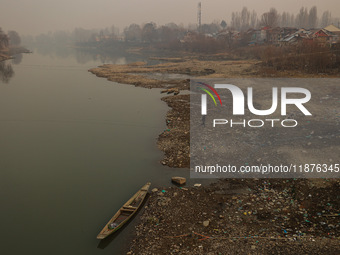 A man walks toward the shore of River Jehlum on a cold winter day in Baramulla, Jammu and Kashmir, India, on December 17, 2024. (