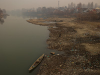 A man walks toward the shore of River Jehlum on a cold winter day in Baramulla, Jammu and Kashmir, India, on December 17, 2024. (