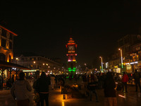 Indian tourists and local people walk near the Clock Tower (Ghanta Ghar) on a cold evening in Srinagar, Jammu and Kashmir, on December 17, 2...