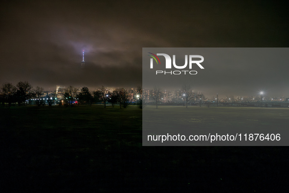 Part of the New York City skyline is seen through dense fog covering Liberty State Park following rainfall in Jersey City, NJ, U.S., on Dece...