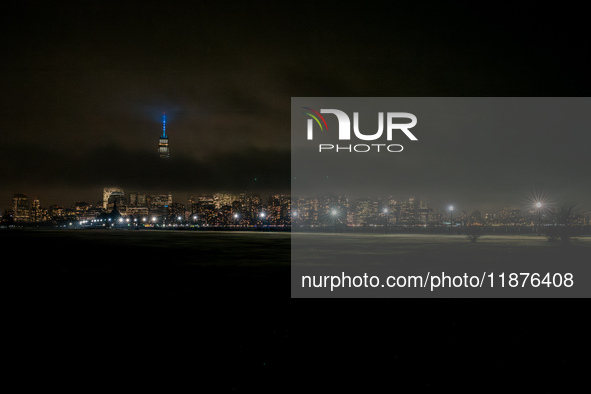 Part of the New York City skyline is seen through dense fog covering Liberty State Park following rainfall in Jersey City, NJ, U.S., on Dece...