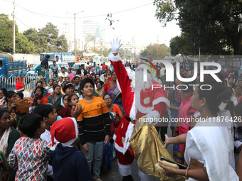 A Protestant Christian man dressed as Santa Claus attends a pre-Christmas celebration in Kolkata, India, on December 17, 2024. Protestantism...