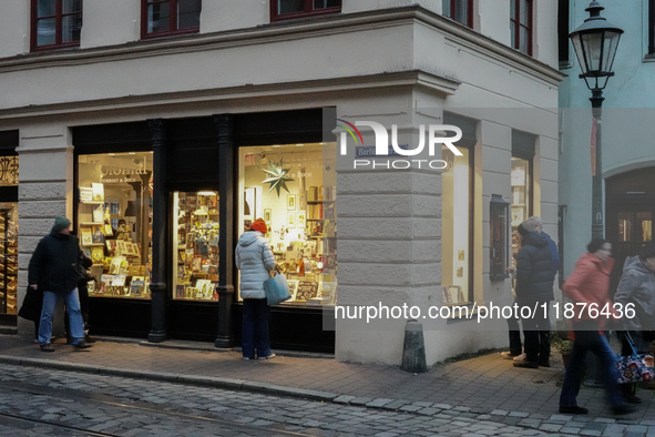 People are outside on the streets in Augsburg, Bavaria, Germany, on December 14, 2024, looking for gifts and presents. 