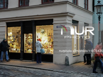 People are outside on the streets in Augsburg, Bavaria, Germany, on December 14, 2024, looking for gifts and presents. (