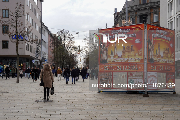 A promotional display announces the dates of the Augsburg Christkindlesmarkt, one of Germany's Christmas markets, on December 14, 2024. A wo...