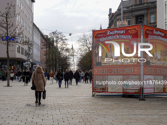 A promotional display announces the dates of the Augsburg Christkindlesmarkt, one of Germany's Christmas markets, on December 14, 2024. A wo...