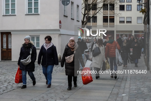 People are outside on the streets in Augsburg, Bavaria, Germany, on December 14, 2024, looking for gifts and presents. 