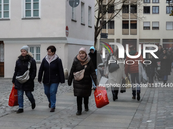 People are outside on the streets in Augsburg, Bavaria, Germany, on December 14, 2024, looking for gifts and presents. (