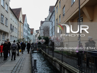 People are outside on the streets in Augsburg, Bavaria, Germany, on December 14, 2024, looking for gifts and presents. (