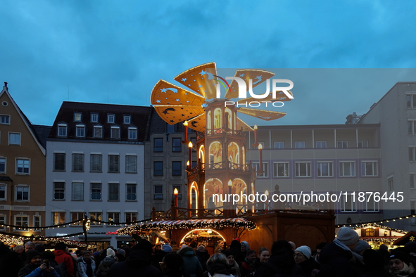 People are outside on the streets in Augsburg, Bavaria, Germany, on December 14, 2024, looking for gifts and presents. 