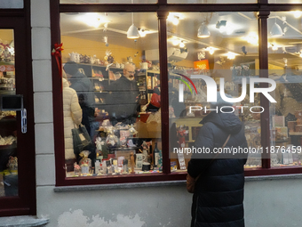 People are outside on the streets in Augsburg, Bavaria, Germany, on December 14, 2024, looking for gifts and presents. (