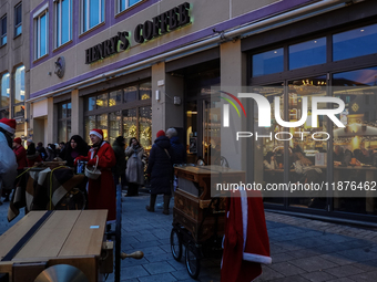 People are outside on the streets in Augsburg, Bavaria, Germany, on December 14, 2024, looking for gifts and presents. (