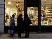 People are outside on the streets in Augsburg, Bavaria, Germany, on December 14, 2024, looking for gifts and presents. (