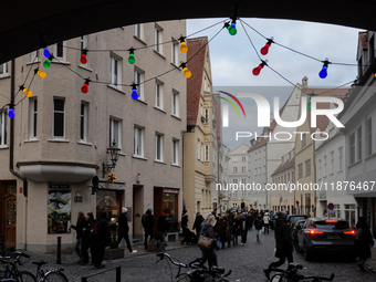 People are outside on the streets in Augsburg, Bavaria, Germany, on December 14, 2024, looking for gifts and presents. (