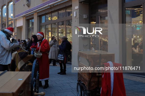 People are outside on the streets in Augsburg, Bavaria, Germany, on December 14, 2024, looking for gifts and presents. 