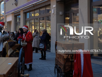 People are outside on the streets in Augsburg, Bavaria, Germany, on December 14, 2024, looking for gifts and presents. (