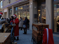 People are outside on the streets in Augsburg, Bavaria, Germany, on December 14, 2024, looking for gifts and presents. (