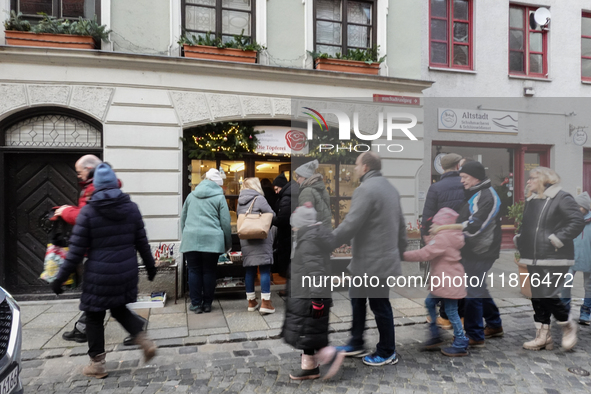 People are outside on the streets in Augsburg, Bavaria, Germany, on December 14, 2024, looking for gifts and presents. 