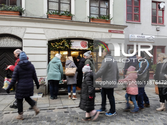 People are outside on the streets in Augsburg, Bavaria, Germany, on December 14, 2024, looking for gifts and presents. (