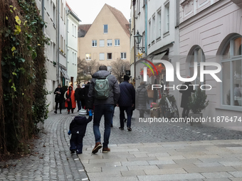 People are outside on the streets in Augsburg, Bavaria, Germany, on December 14, 2024, looking for gifts and presents. (