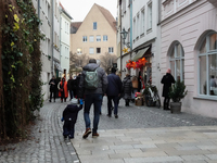 People are outside on the streets in Augsburg, Bavaria, Germany, on December 14, 2024, looking for gifts and presents. (