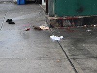 Objects from the victim are on the ground. A man is stabbed multiple times to death outside of Mucho Luco Deli Grocery in Brownsville, Brook...