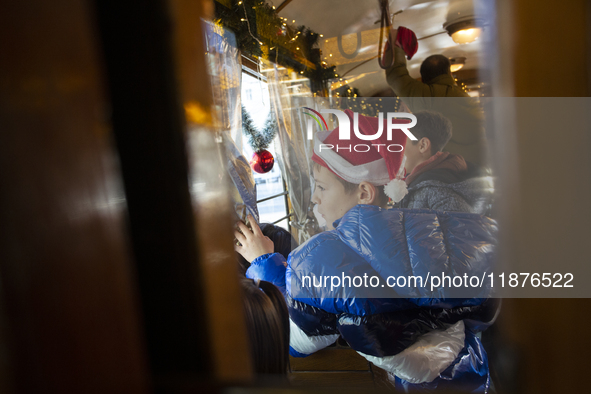 A Christmas retro tram with Santa Claus and Snow White is in Sofia, Bulgaria, on December 17, 2024. The retro tram, which is 115 years old,...