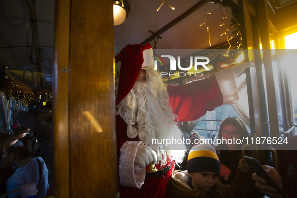 A Christmas retro tram with Santa Claus and Snow White is in Sofia, Bulgaria, on December 17, 2024. The retro tram, which is 115 years old,...