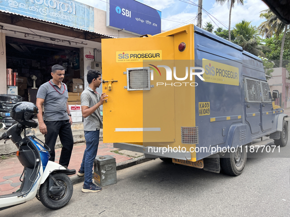 Cash is loaded into an armored vehicle outside a bank in Thiruvananthapuram, Kerala, India, on April 15, 2024. 