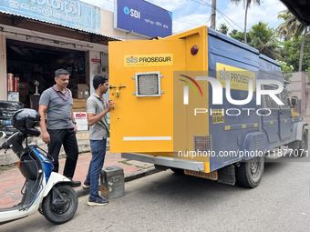 Cash is loaded into an armored vehicle outside a bank in Thiruvananthapuram, Kerala, India, on April 15, 2024. (