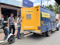 Cash is loaded into an armored vehicle outside a bank in Thiruvananthapuram, Kerala, India, on April 15, 2024. (