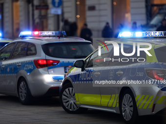 A police car with lights on is on the street in Warsaw, Poland, on December 12, 2024. (