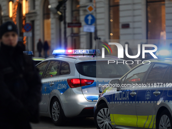 A police car with lights on is on the street in Warsaw, Poland, on December 12, 2024. (