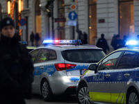 A police car with lights on is on the street in Warsaw, Poland, on December 12, 2024. (