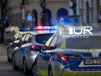 A police car with lights on is on the street in Warsaw, Poland, on December 12, 2024. (