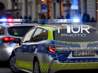 A police car with lights on is on the street in Warsaw, Poland, on December 12, 2024. (