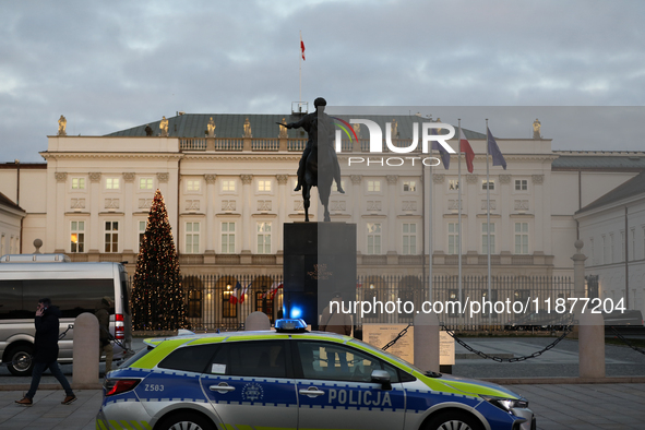 A police car with lights on is in front of the Presidential Palace in Warsaw, Poland, on December 12, 2024. 