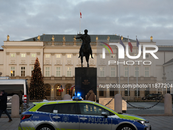 A police car with lights on is in front of the Presidential Palace in Warsaw, Poland, on December 12, 2024. (