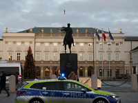 A police car with lights on is in front of the Presidential Palace in Warsaw, Poland, on December 12, 2024. (