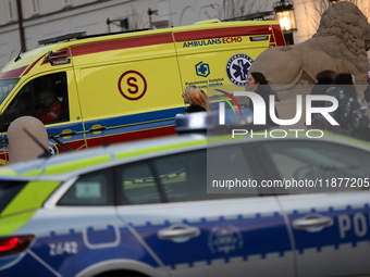 An ambulance and a police car with lights on are on the street in Warsaw, Poland, on December 12, 2024. (