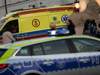 An ambulance and a police car with lights on are on the street in Warsaw, Poland, on December 12, 2024. (