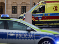 An ambulance and a police car with lights on are on the street in Warsaw, Poland, on December 12, 2024. (