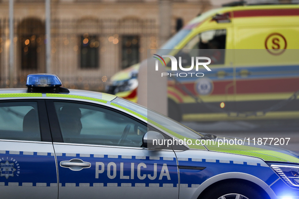 A police car with lights and an ambulance are on the street in Warsaw, Poland, on December 12, 2024. 