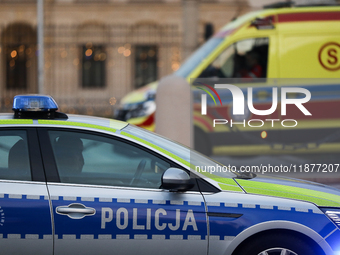 A police car with lights and an ambulance are on the street in Warsaw, Poland, on December 12, 2024. (